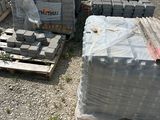a lot of bricks and pallets sitting on the ground