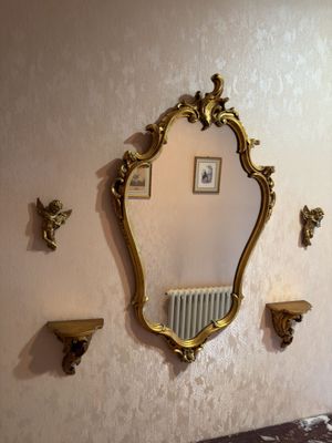 a mirror on the wall above a radiator in a room