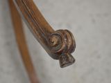 a close up of a wooden chair with a metal handle