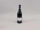 la bouteille de vin est posée sur une surface blanche
