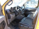 the interior of a yellow truck with a steering wheel and dashboard