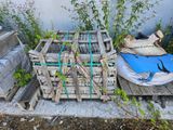 a pile of wooden pallets sitting on the ground next to a wall