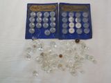 two bags of buttons and some beads on a table
