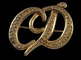 an image of a gold broochle with diamonds on it