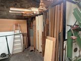 several pieces of wood are stacked up in a room with a ladder