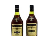two bottles of wine sitting next to each other on a white surface