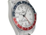 a close up of a wrist watch with a red, white and blue bezel