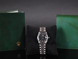 a watch that is sitting next to a wallet