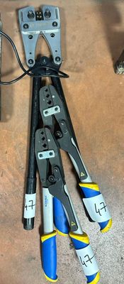 wires and pliers are laying on a table next to a pair of pliers