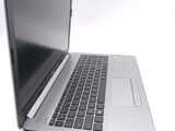 a silver laptop with a black keyboard on a white surface