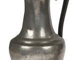 a silver vase with a flower on it on a white background