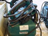 a green air compressor sitting on top of a table
