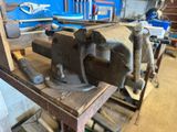 an old vise on a workbench in a workshop