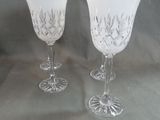 two wine glasses sitting next to each other on a table