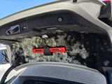 a car that has been covered in snow with the hood up