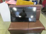 a television sitting on top of a couch in a room