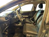 the interior of a car with the door open and the driver ' s seat down