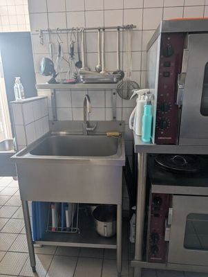 a kitchen with a sink and a microwave in it
