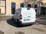 a white van that is parked in front of a building