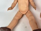 a doll that is sitting next to a basketball ball