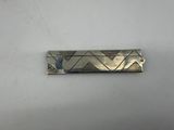 an image of a silver plate with a design on it