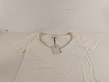 a white t - shirt sitting on top of a white table
