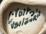 a white vase with writing on it sitting on a table