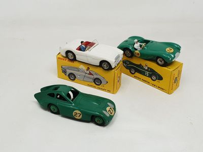 three toy cars that are sitting on top of a box