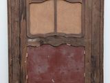 an old wooden window with a red painted glass panel