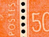 un gros plan sur un morceau de papier orange parsemé de points noirs
