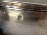 a close up of a silver plate on a table