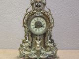 a clock that is sitting on a table with a key in it