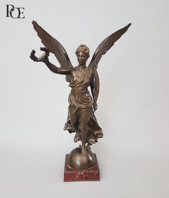 an image of a statue of an angel holding a bird on top of a ball