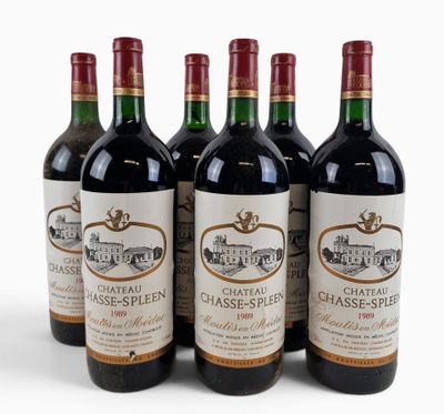 six bottles of chateau classe - spessie wine lined up on a white surface