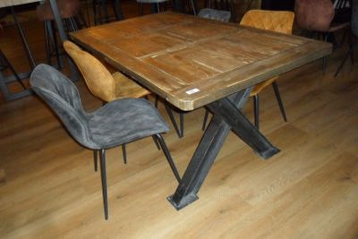 a wooden table with chairs around it in a room