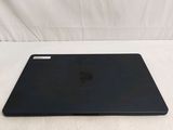 a black apple laptop sitting on a white surface