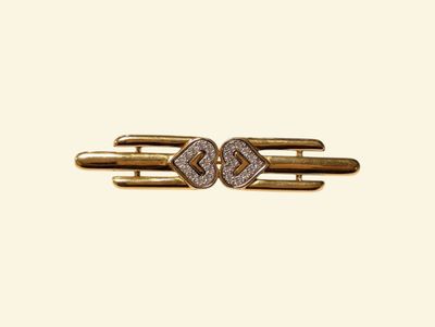 a close up of a gold and diamond hair clip