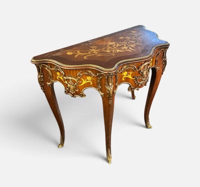 an image of a small table with a wooden top and gold decorations