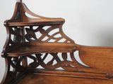 a wooden shelf that has three shelves on top of it