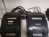 two receipt machines sitting on a shelf next to each other