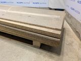 several pieces of plywood are stacked on a pallet in a warehouse