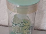 a glass jar with ice in it sitting on a table