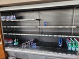 many bottles of water sitting on the shelves in the store