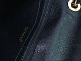 a black purse with a gold chain hanging from it