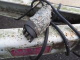 a close up of a bicycle with wires attached to it