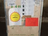 a cardboard box with a sign on it sitting in front of a brick wall