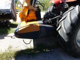 a tractor that is parked on the side of the road