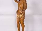 an antique wooden statue of jesus with a halo on his head