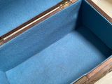 an open suitcase sitting on a table with a blue cover