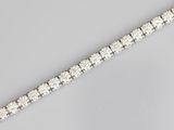 a close up of a diamond bracelet on a table